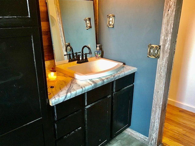 bathroom with vanity and wood-type flooring