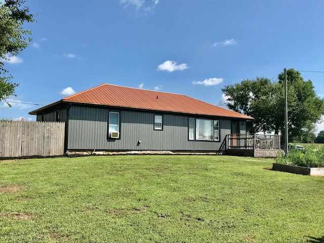 back of property with a lawn, a wooden deck, and cooling unit