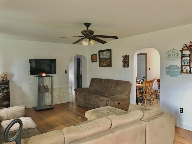 living room with ceiling fan and hardwood / wood-style flooring