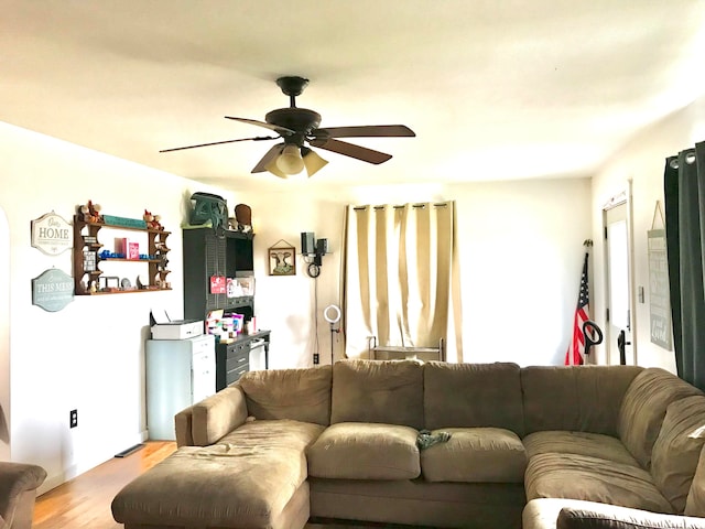 living room featuring ceiling fan and light wood-type flooring