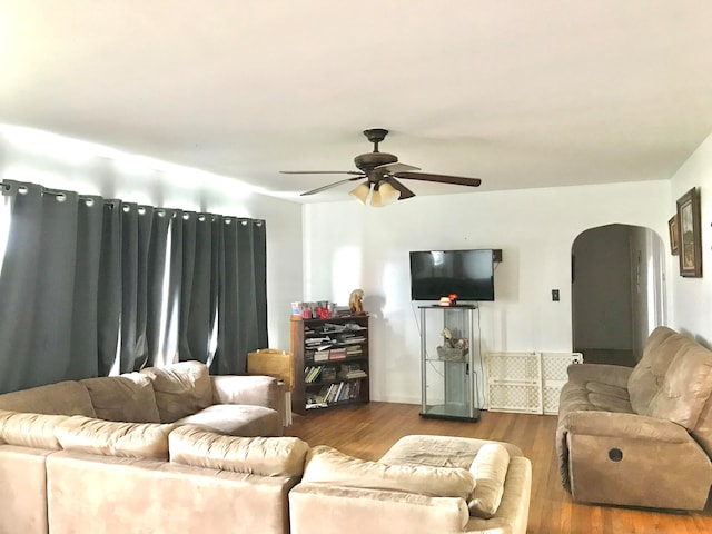 living room with ceiling fan and wood-type flooring