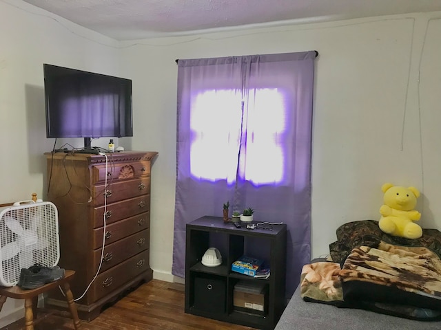 bedroom with dark wood-type flooring