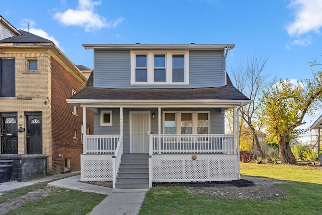 view of front facade with covered porch and a front lawn