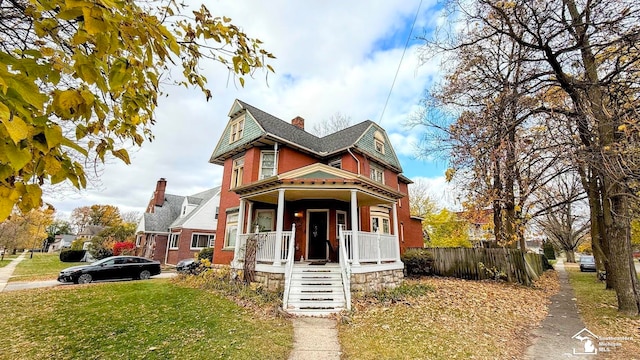 victorian-style house with covered porch and a front yard