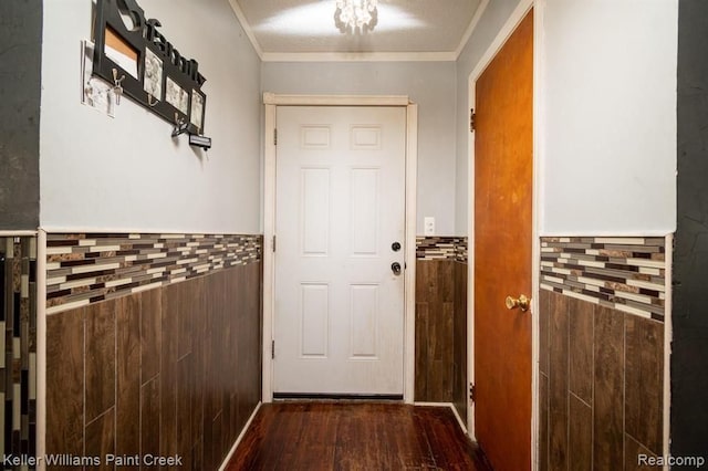 entryway with crown molding, dark hardwood / wood-style flooring, and a textured ceiling