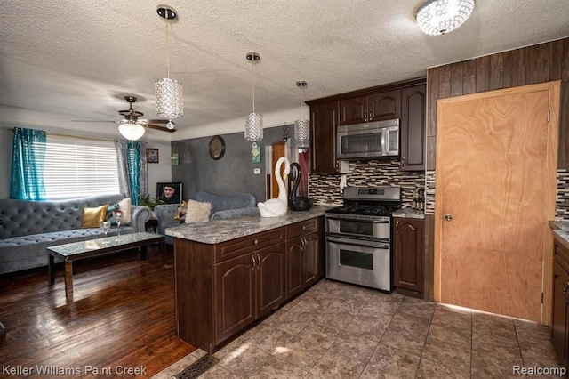 kitchen with pendant lighting, kitchen peninsula, appliances with stainless steel finishes, dark hardwood / wood-style flooring, and dark brown cabinetry