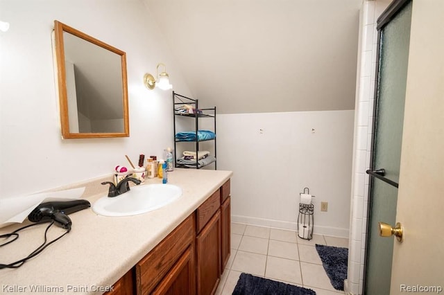 bathroom featuring tile patterned flooring, vanity, vaulted ceiling, and walk in shower