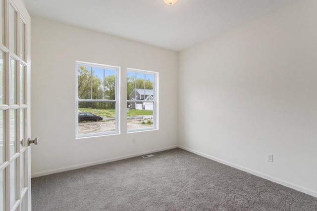 carpeted empty room with french doors