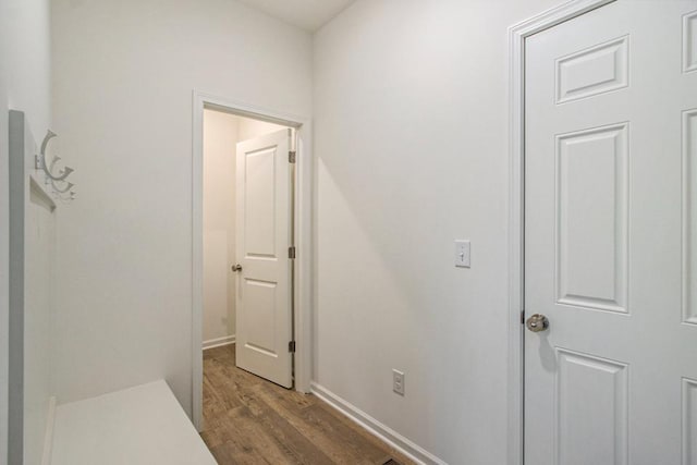 corridor with dark hardwood / wood-style flooring