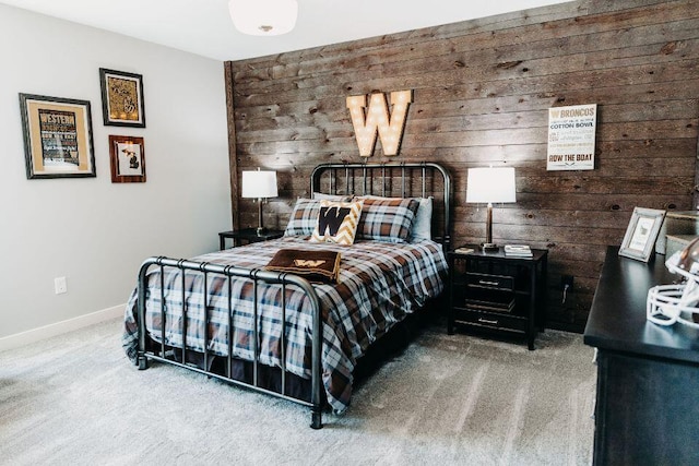 carpeted bedroom with wooden walls