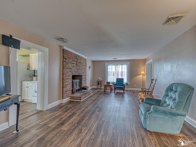 living room featuring a fireplace and dark hardwood / wood-style floors