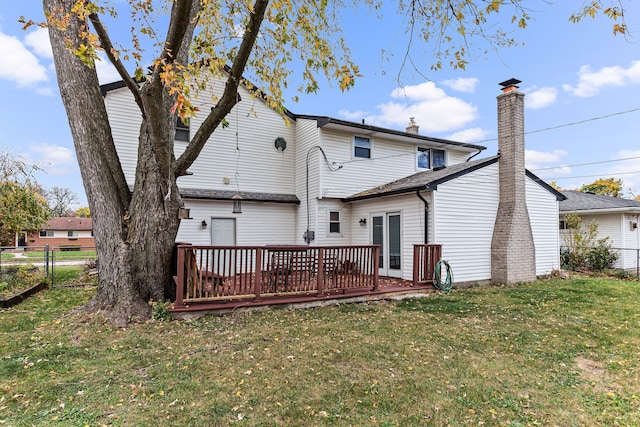 rear view of property with a lawn and a wooden deck