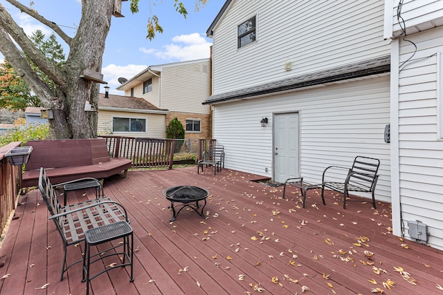 wooden deck with an outdoor fire pit