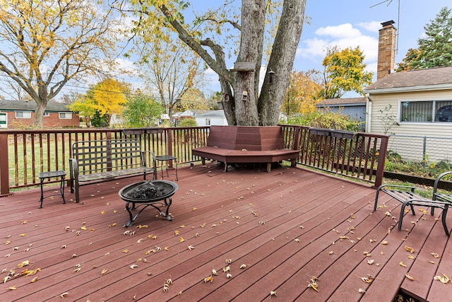 wooden terrace with an outdoor fire pit