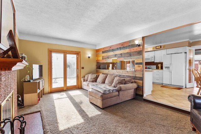 carpeted living room featuring a tile fireplace, a textured ceiling, and sink