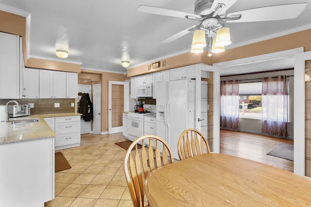 kitchen featuring decorative backsplash, white cabinetry, white appliances, and sink