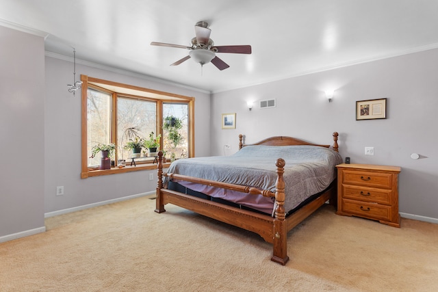 carpeted bedroom featuring ceiling fan and ornamental molding