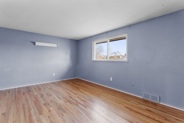 spare room with light hardwood / wood-style floors