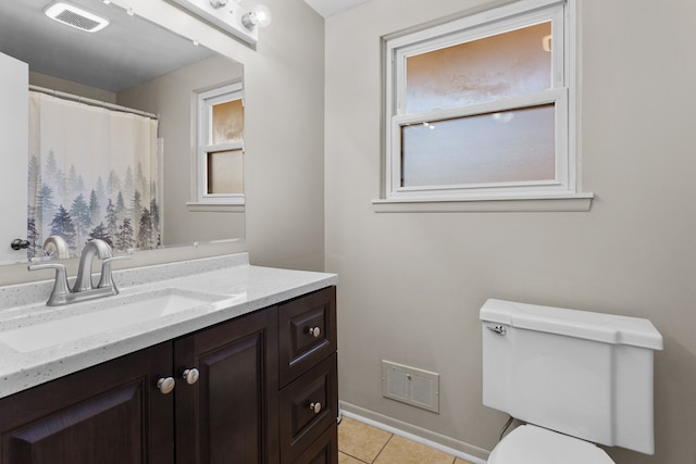 bathroom featuring tile patterned flooring, vanity, and toilet