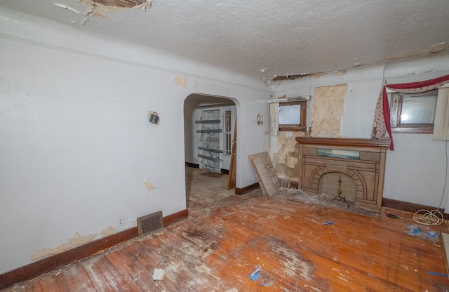 unfurnished living room with hardwood / wood-style flooring