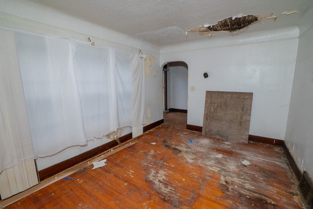 unfurnished room with dark hardwood / wood-style flooring