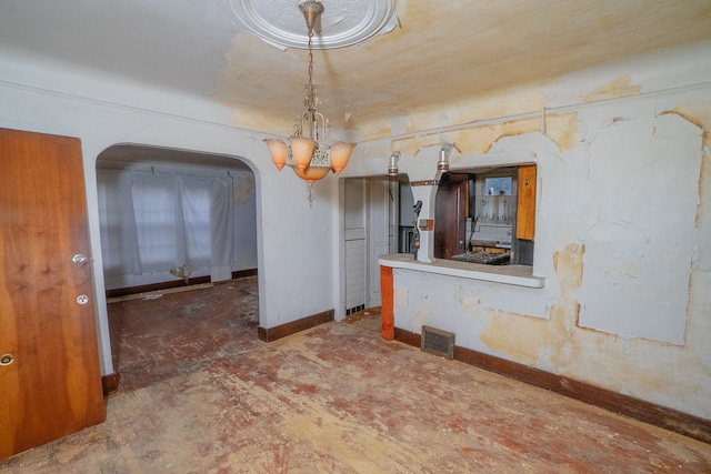 unfurnished dining area featuring a chandelier