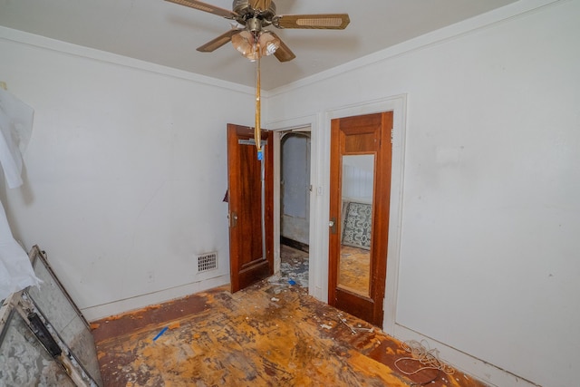 spare room featuring ceiling fan and crown molding