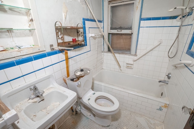 full bathroom with tile patterned flooring, tiled shower / bath combo, tile walls, and toilet