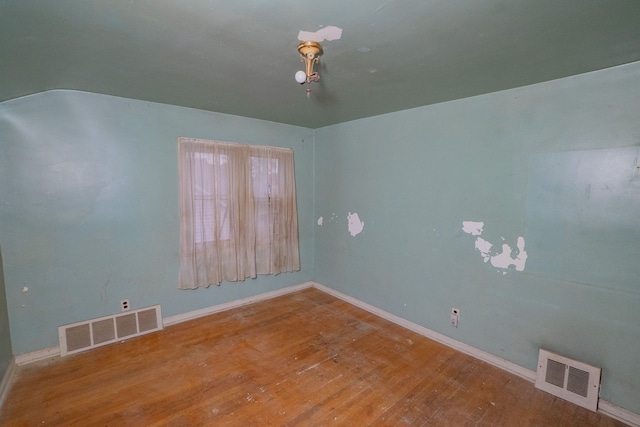 unfurnished room featuring hardwood / wood-style floors