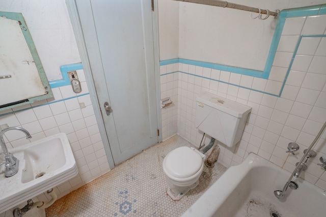 full bathroom with sink, tiled shower / bath combo, tile patterned floors, toilet, and tile walls