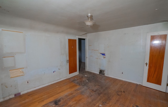 unfurnished room with hardwood / wood-style floors