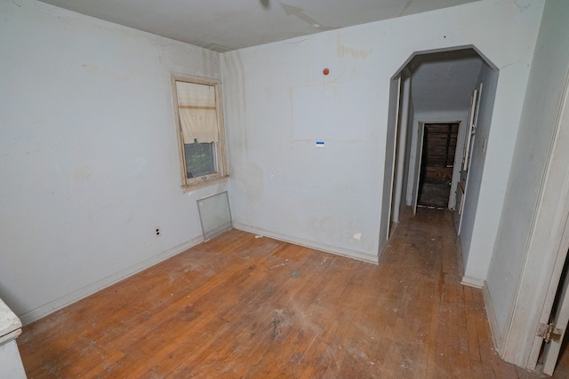 empty room with hardwood / wood-style flooring