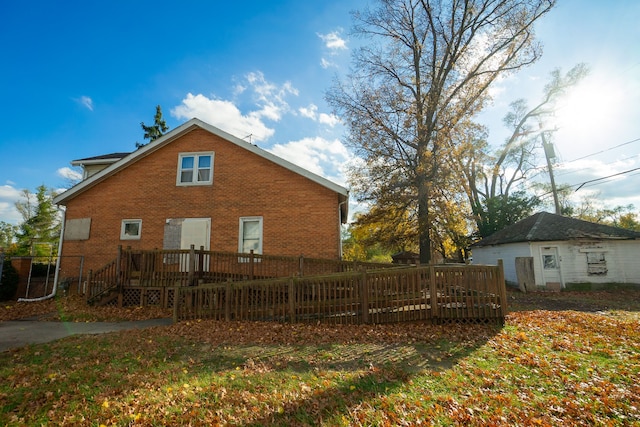 back of house featuring a wooden deck