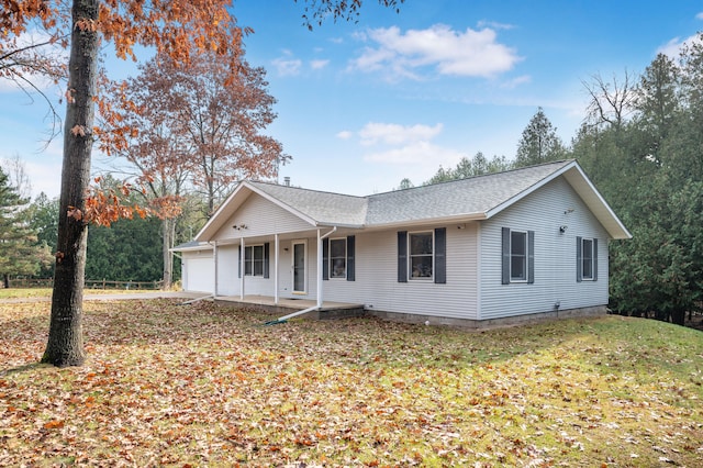 single story home with a garage and a front lawn