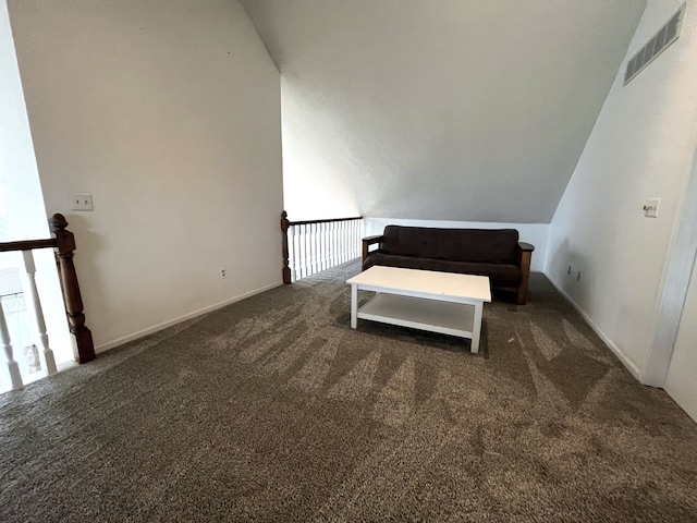 unfurnished bedroom featuring dark carpet and lofted ceiling