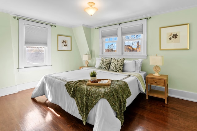 bedroom featuring dark hardwood / wood-style flooring, crown molding, and multiple windows