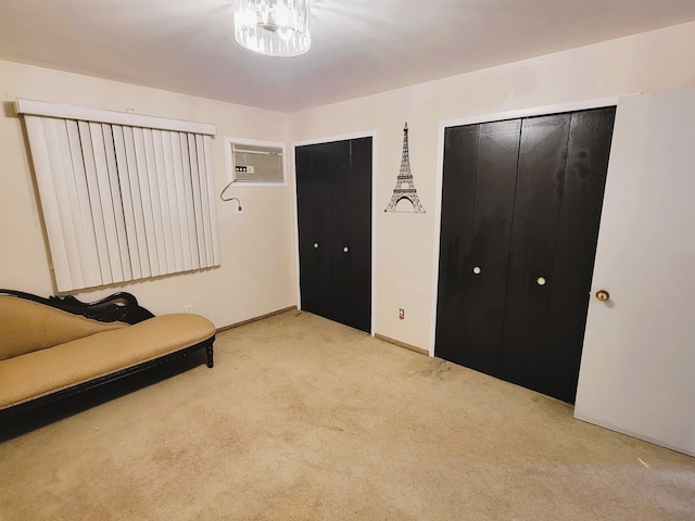 unfurnished room with an AC wall unit and light carpet