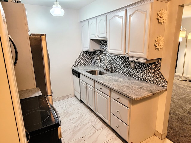 kitchen featuring sink, tasteful backsplash, light stone counters, white appliances, and light carpet