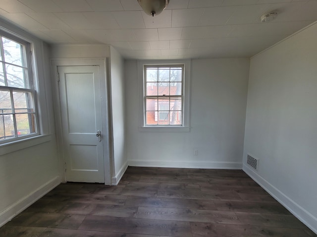 empty room with dark wood-type flooring