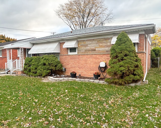 view of side of home featuring a yard