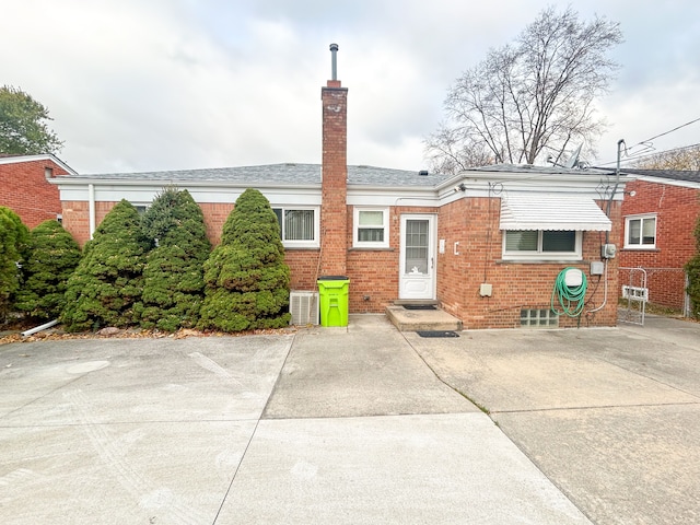 back of house featuring central AC unit