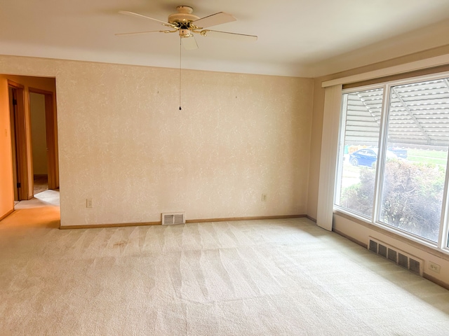 empty room with light carpet and ceiling fan