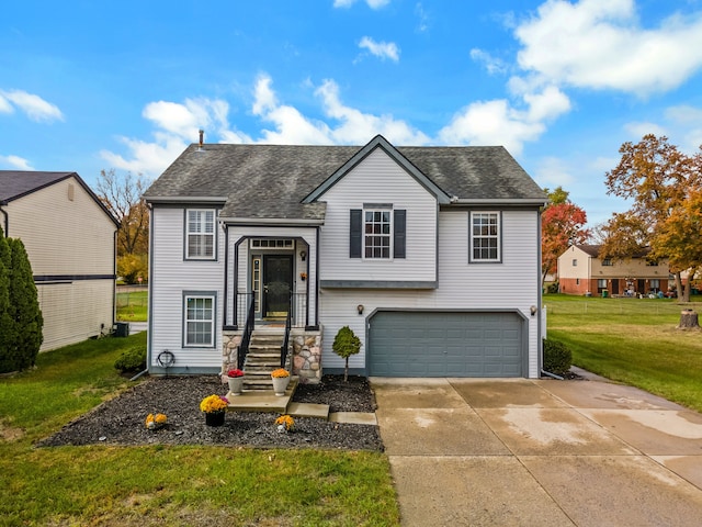 bi-level home with a front yard and a garage