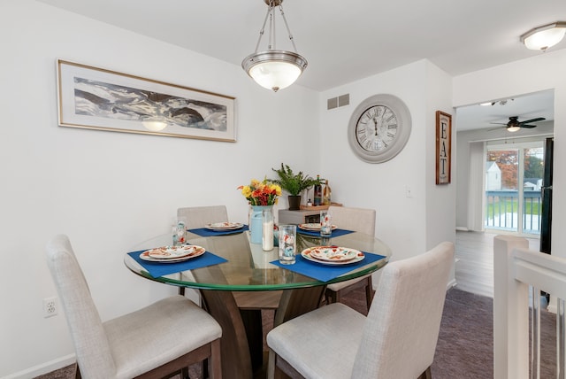 dining area with carpet and ceiling fan