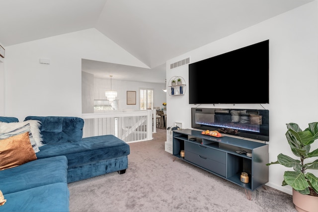 living room with carpet and vaulted ceiling