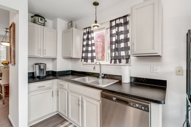 kitchen featuring pendant lighting, dishwasher, dark wood-type flooring, white cabinets, and sink