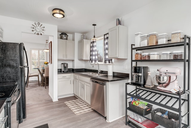 kitchen with white cabinetry, a healthy amount of sunlight, sink, and stainless steel appliances