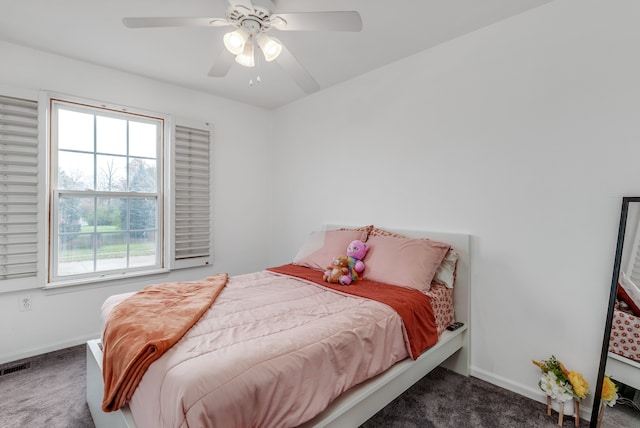 bedroom featuring dark carpet and ceiling fan