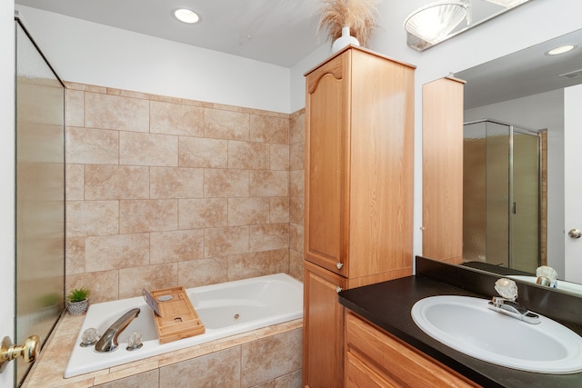 bathroom with vanity and independent shower and bath