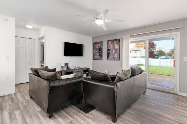 living room with ceiling fan and light wood-type flooring